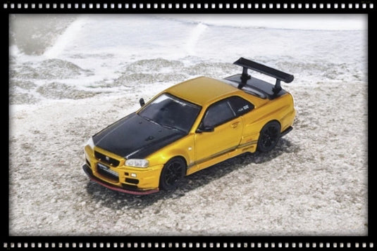 Nissan Skyline GT-R (R34) *Top Secret* Goud/zwart INNO64 Models 1:64