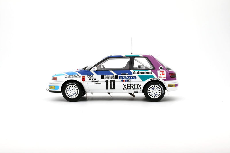 Chargez l&#39;image dans la visionneuse de la galerie, Mazda 323 GTX GR.A BLANC #10 T. MÄKINEN 1000 LACS RALLYE 1991 OTTOmobile 1:18
